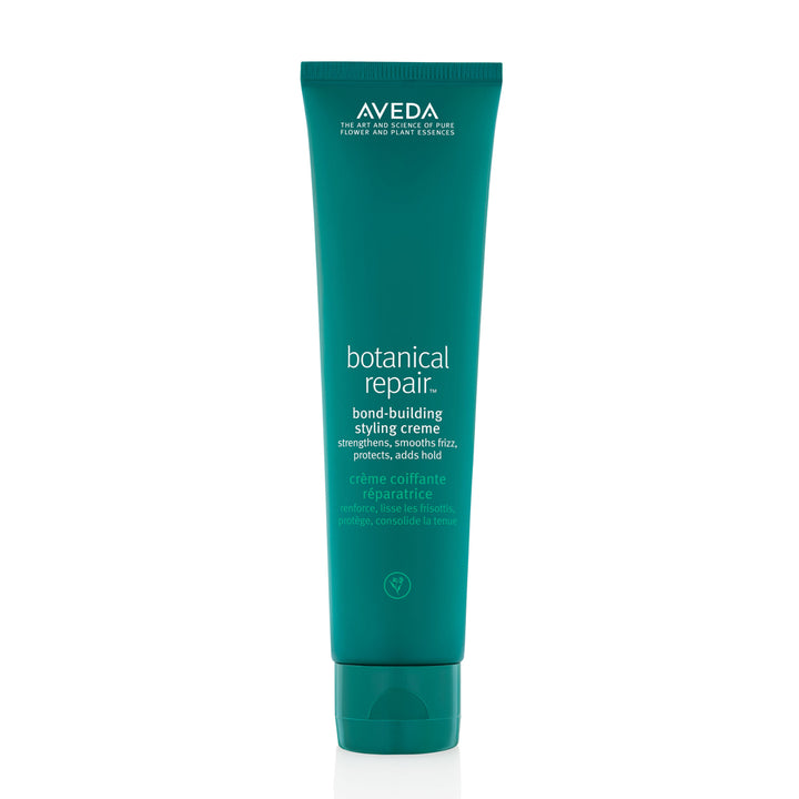 A tube of Aveda Botanical Repair Bond-Building Styling Crème with teal packaging.