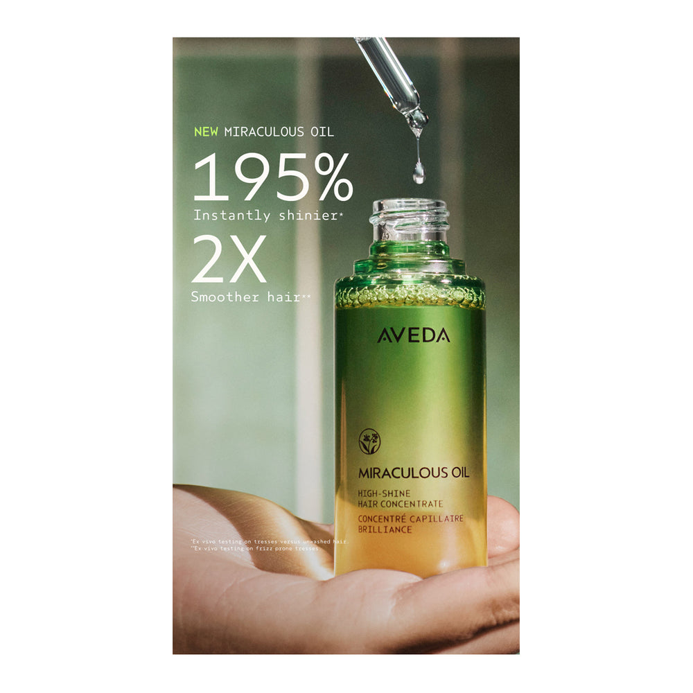 Aveda Miraculous Oil bottle with packaging displaying text about its benefits.
